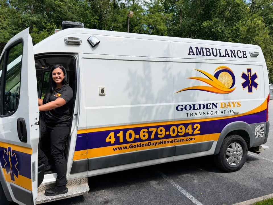 Golden Days team member at the driver’s door of the branded ambulance