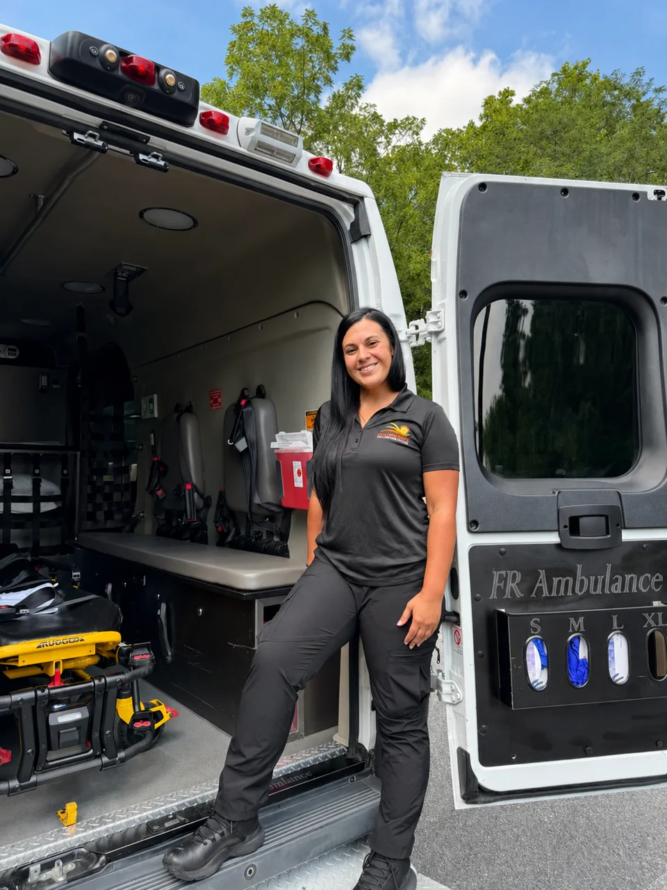 Golden Days team member standing at the open ambulance doors