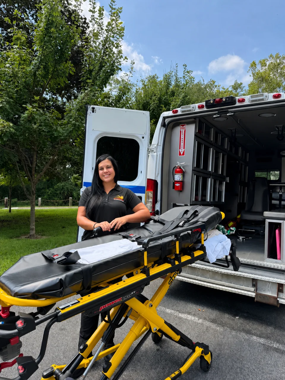 Golden Days team member beside the ambulance stretcher